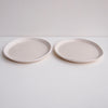 2 white pottery plates