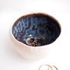 Handmade pottery ring bowl in blue and brown.