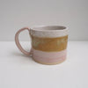 Ceramic mug in pink white and mustard