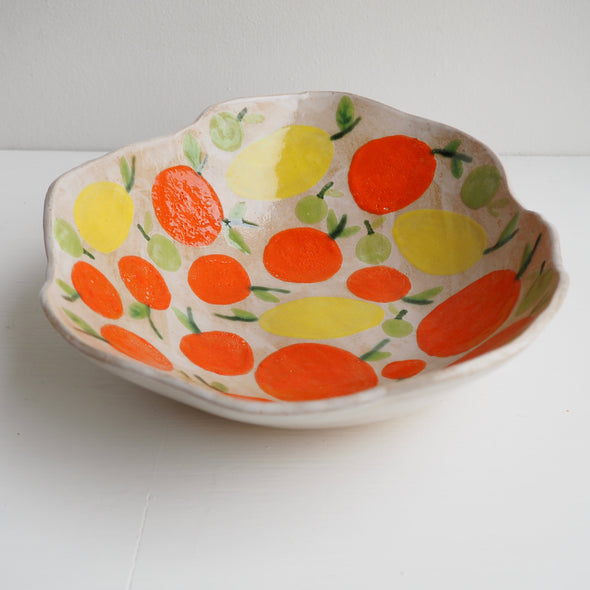Handmade ceramic fruit bowl with oranges , lemons and limes