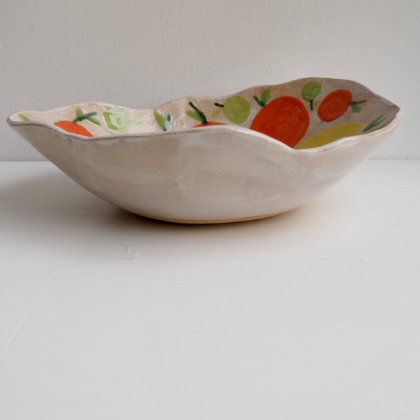 Handmade ceramic fruit bowl with oranges , lemons and limes