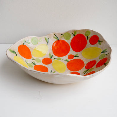Handmade ceramic fruit bowl with oranges , lemons and limes