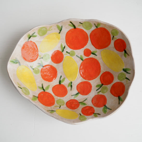 Handmade ceramic fruit bowl with oranges , lemons and limes