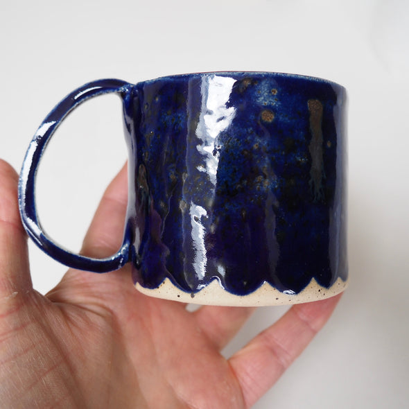 Royal blue ceramic mug with scalloped edge