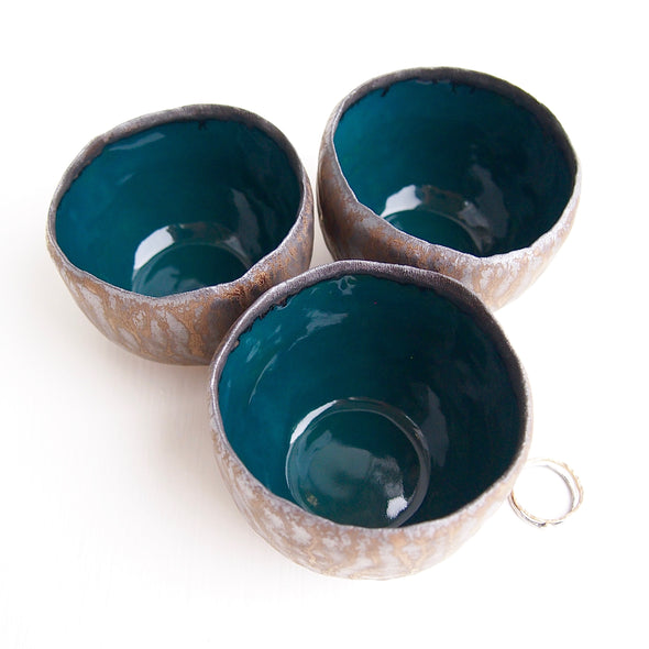 three Teal and gold pottery ring bowls