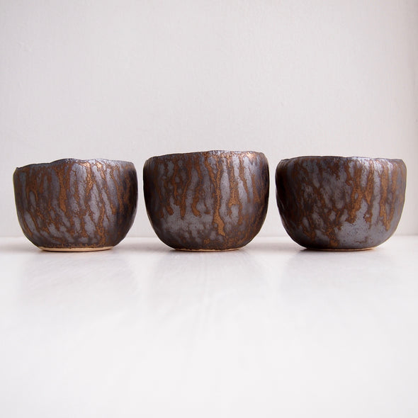 Side view teal and gold pottery ring bowls