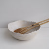 Handmade cream/white speckled scalloped ceramic serving bowl.