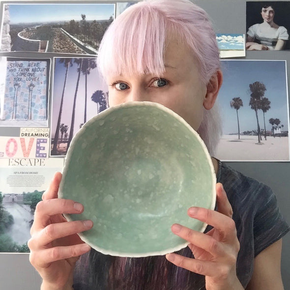 Me holding turquoise and white bowl