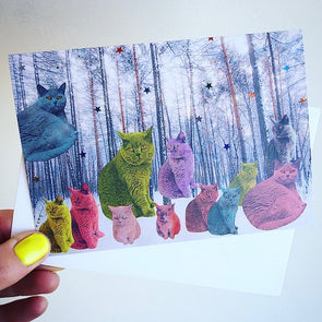 Holding pastel cats in forest card