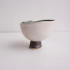 Handmade swirly satin white ceramic ring dish with a gold/black cylinder base