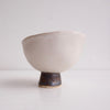 Handmade swirly satin white ceramic ring dish with a gold/black cylinder base