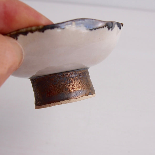 Handmade black/gold and satin white ceramic ring dish with a gold/black cylinder base