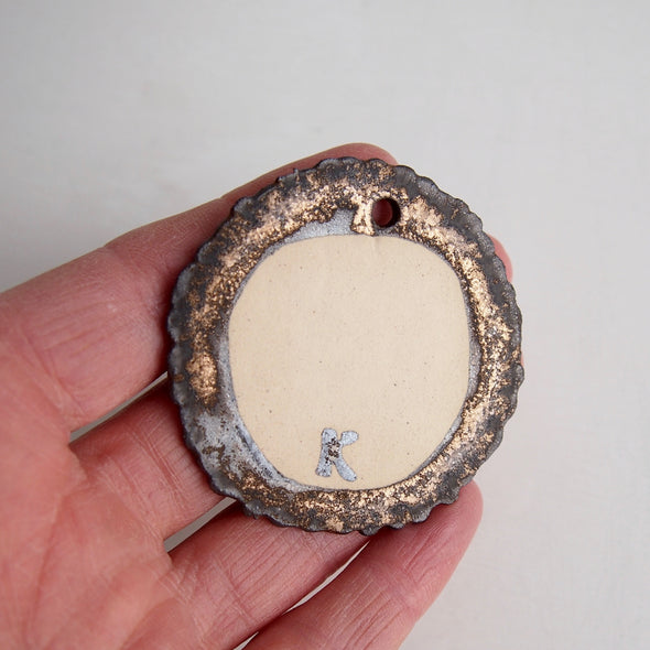 Handmade gold/black crater ceramic necklace