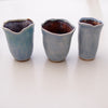 three powder blue mini vases