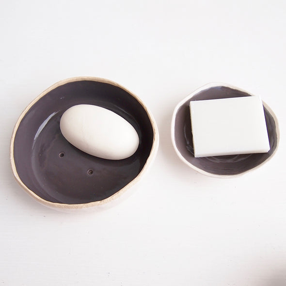 grey pottery soap dishes with soap