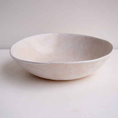 Side of cream speckled pottery cereal bowl