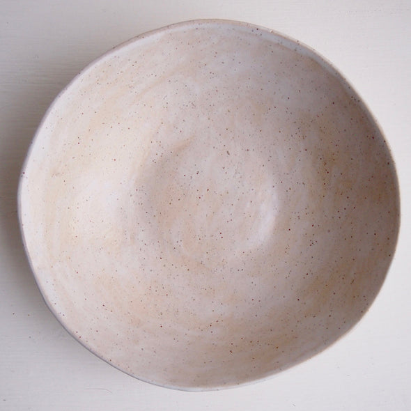 inside of cream speckled pottery bowl