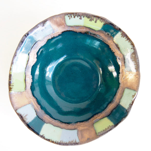 Teal ceramic ring dish with squares and gold detail.