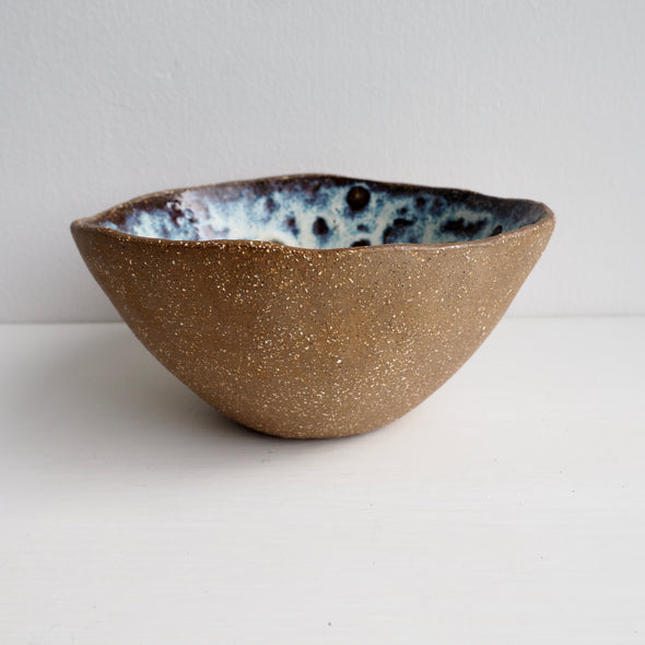 Handmade brown pottery cereal bowl with cream / blue speckled glaze
