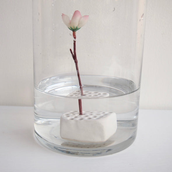 flower frog in vase of water
