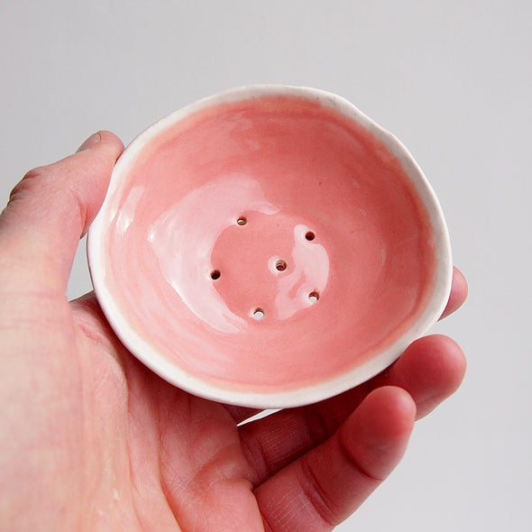 handmade mini pink pottery soap dish in hand