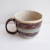 Handmade stripy pottery mug with brown blue turquoise and gold