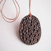 Handmade gold/black crater ceramic necklace