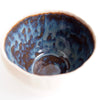 Handmade pottery ring bowl in blue and brown.