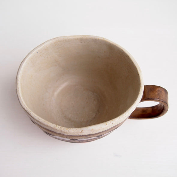 Handmade pottery mug with gold, orange and grey.