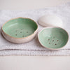 two turquoise soap dishes
