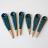 six small teal ceramic spoons