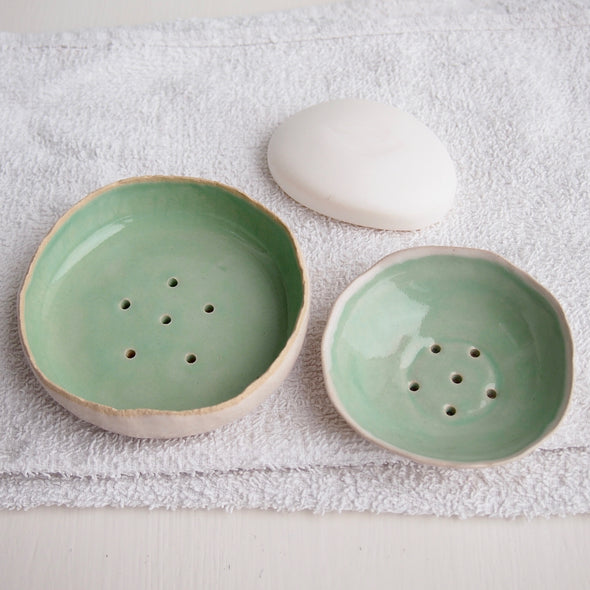 two turquoise ceramic soap dishes